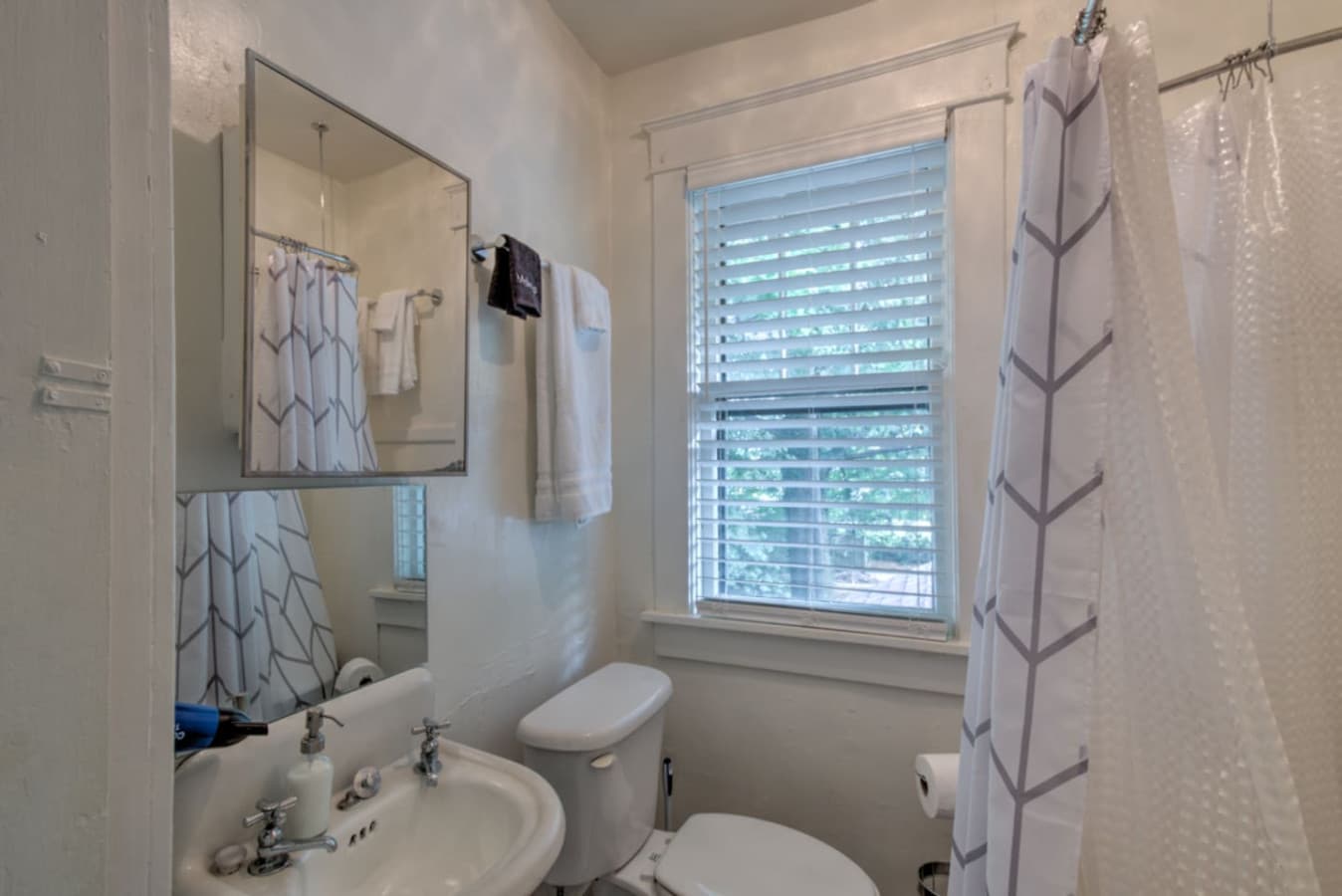 Full-sized bathroom with original claw foot tub.