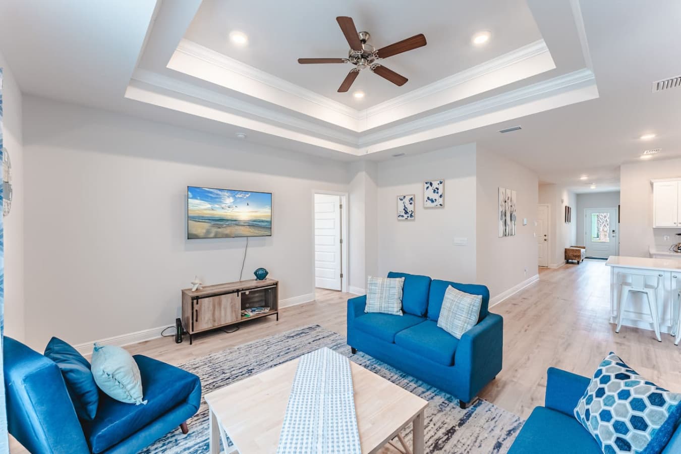 Living Room with 55 inch TV, Sofa, and loveseat. Board Games in TV console.