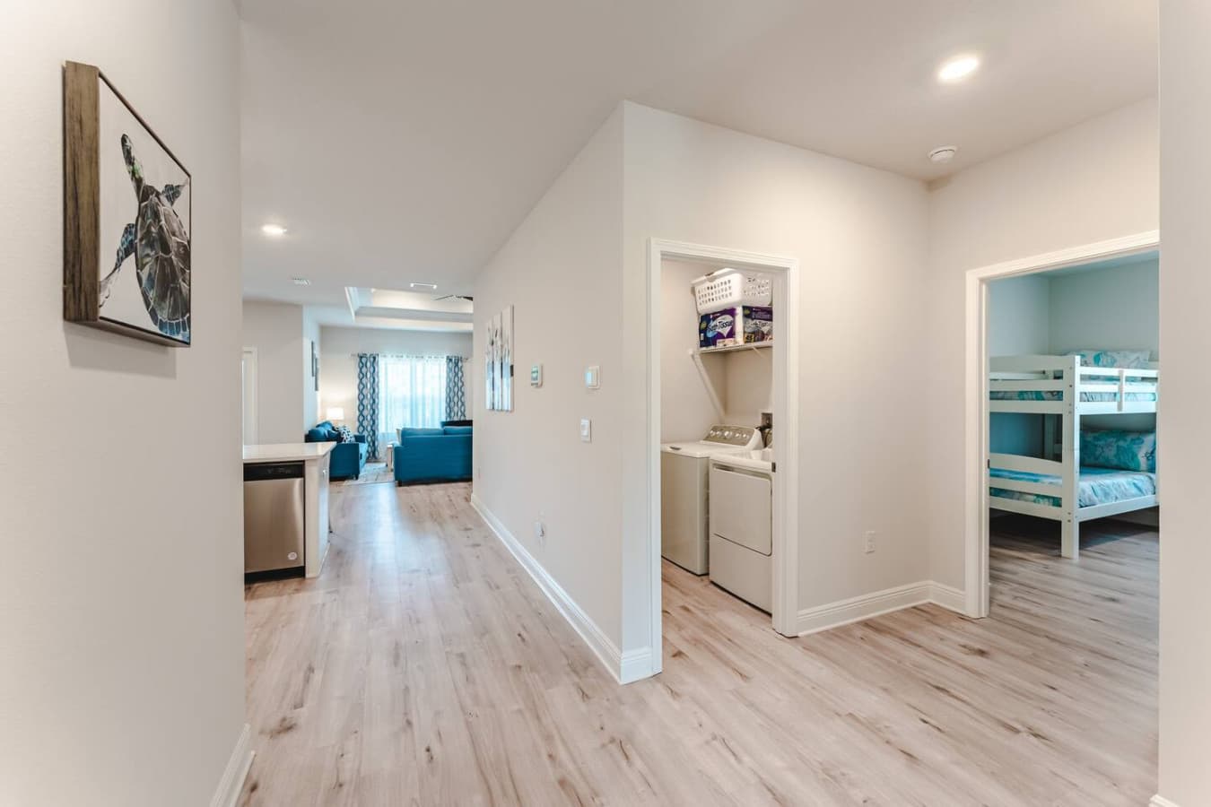 View of the hallway to one of the bedrooms and the laundry room