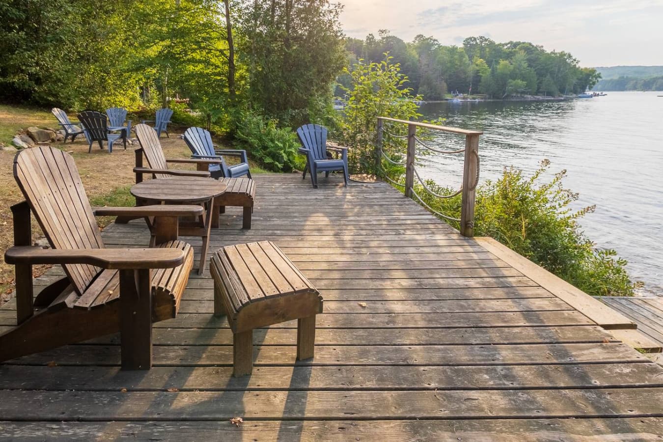 Classic Adirondack chairs positioned for beautiful, uninterrupted lake views.