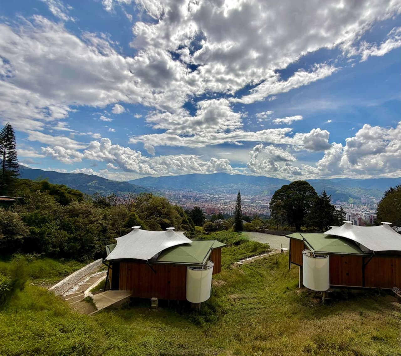 Set within a boutique collection of cabins, surrounded by greenery and skyline views.