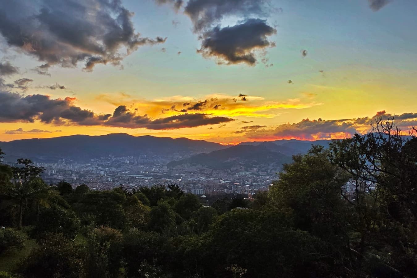 Watch the sky come alive with color as the sun sets over Medellín’s hills and skyline.