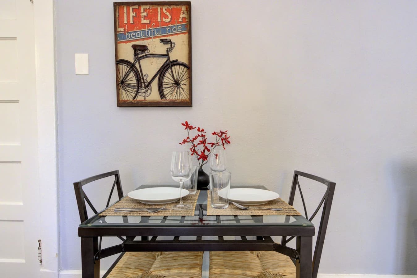 Dining area with a table for two, ideal for meals or a casual workspace.