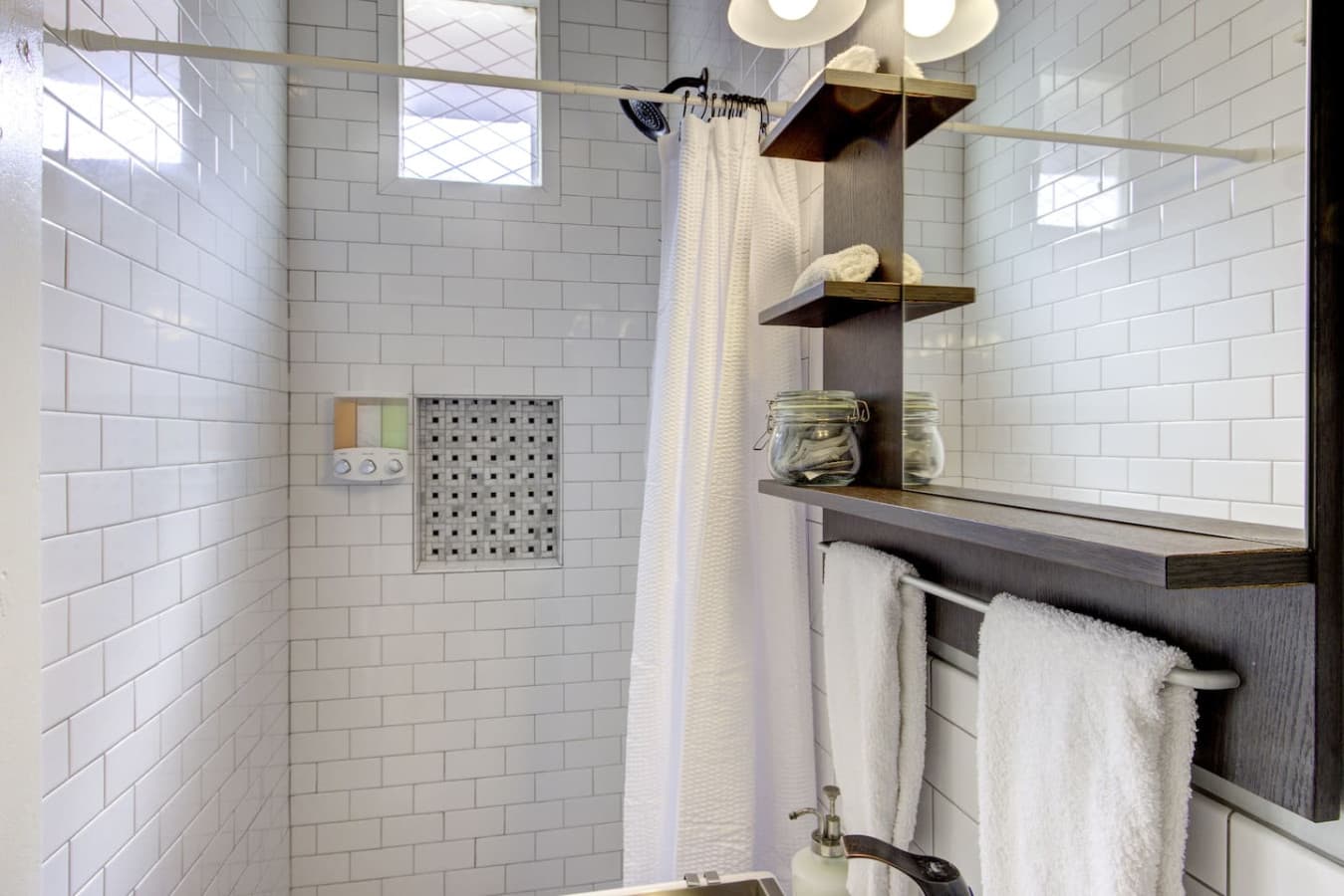 Stand up shower with tiles from floor to ceiling. Soaps also available!