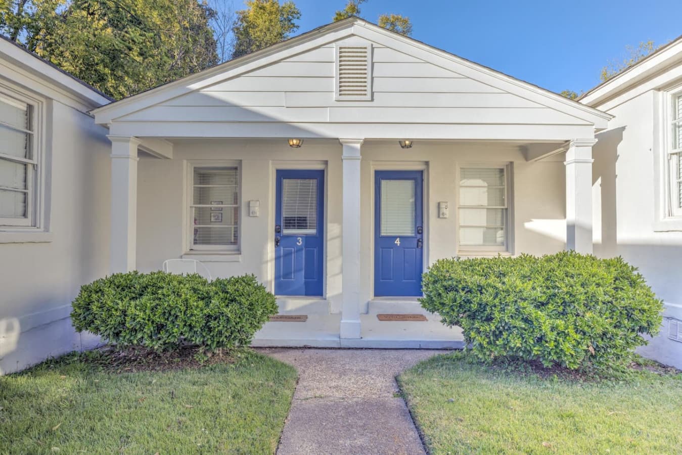 A white cottage with a pop of blue—ready to make memories.