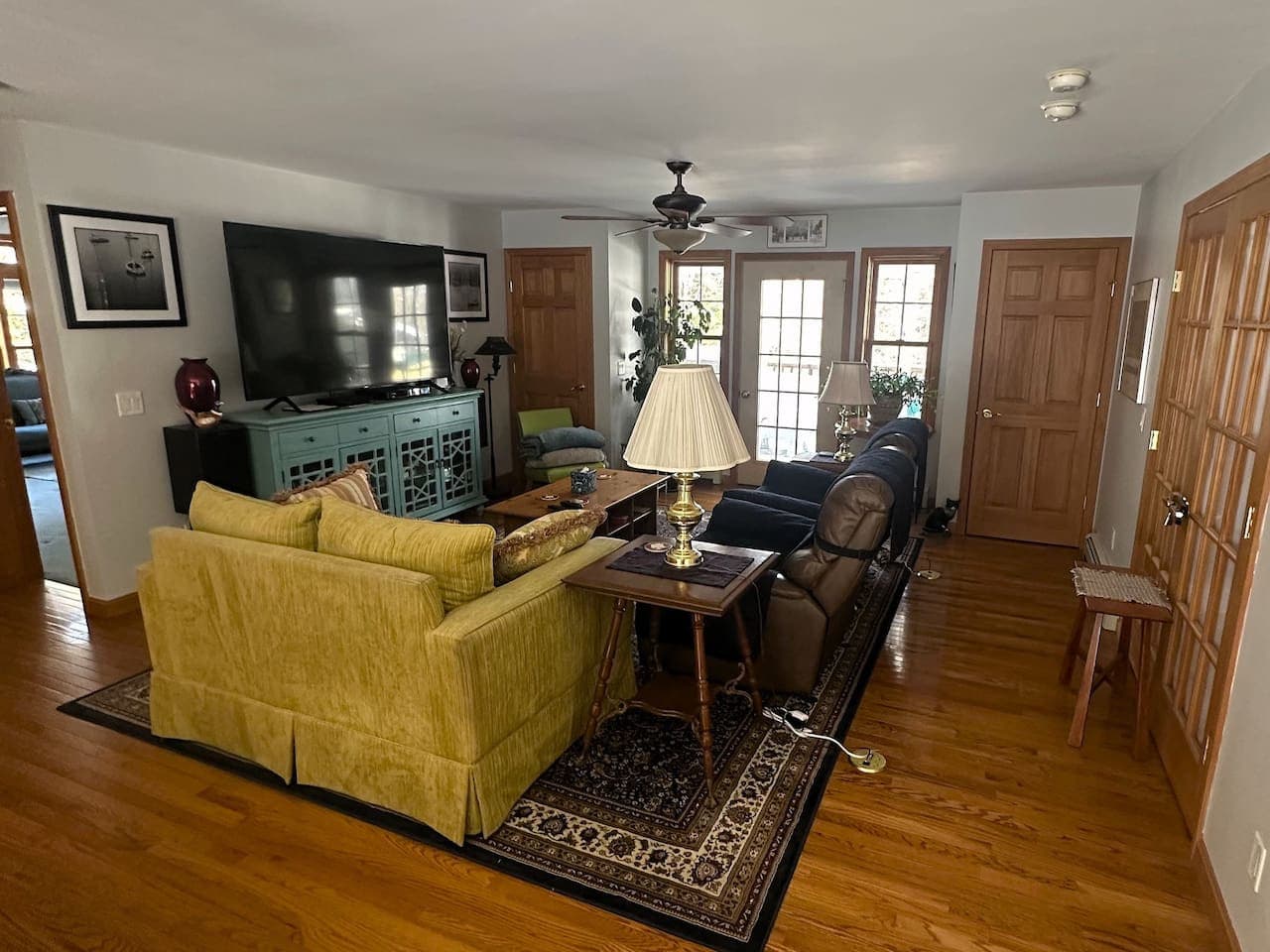 Spacious living area centered around a 75” smart TV.