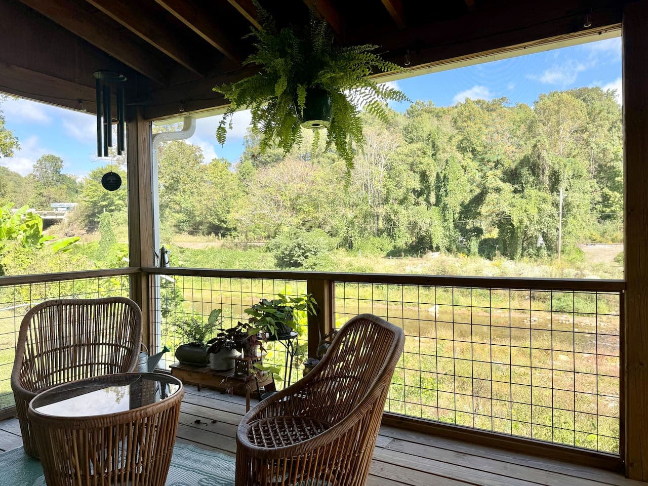 Covered porch + creek views = pure relaxation.