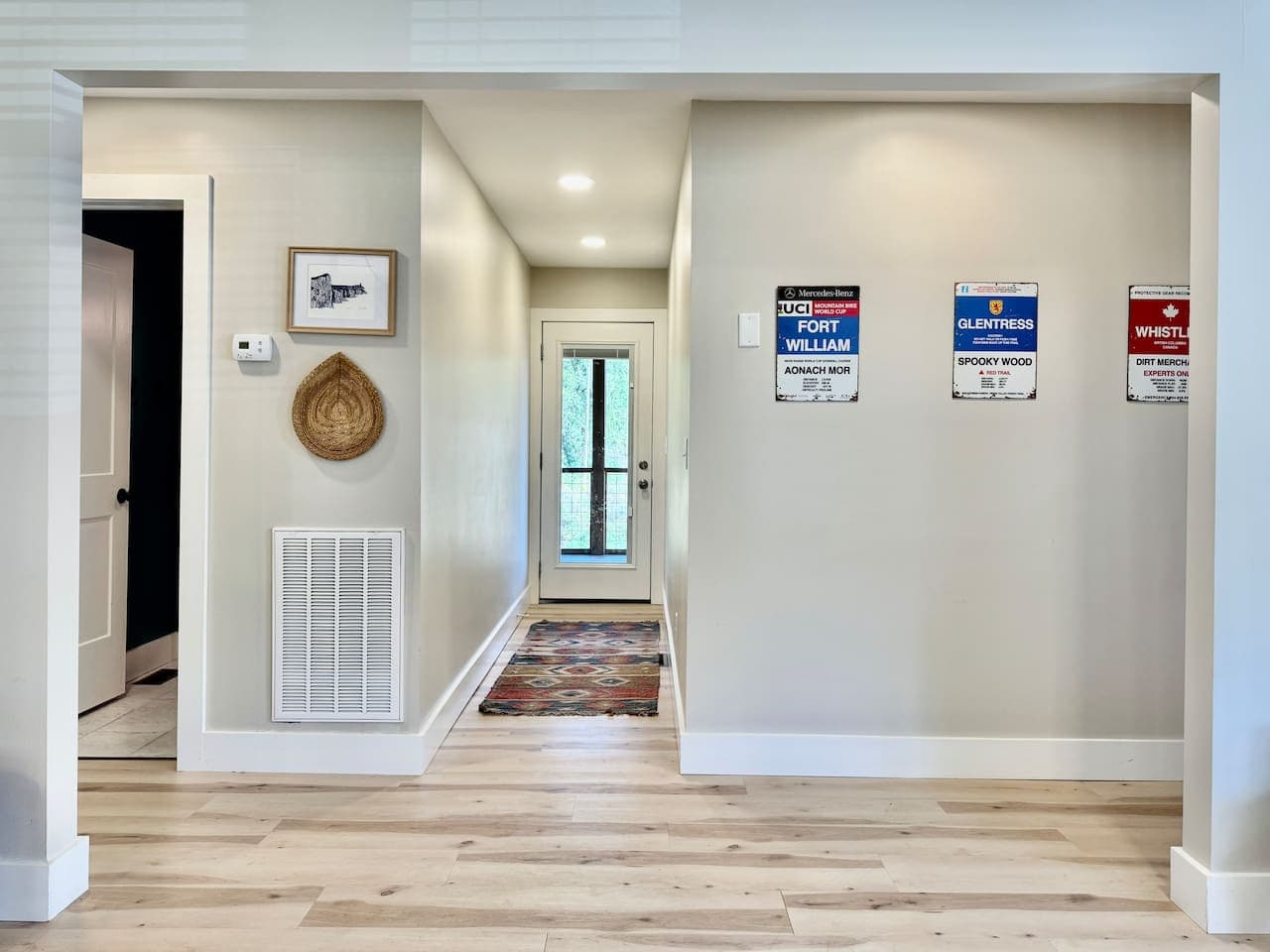 A welcoming hallway with cozy decor and easy climate control at your fingertips.