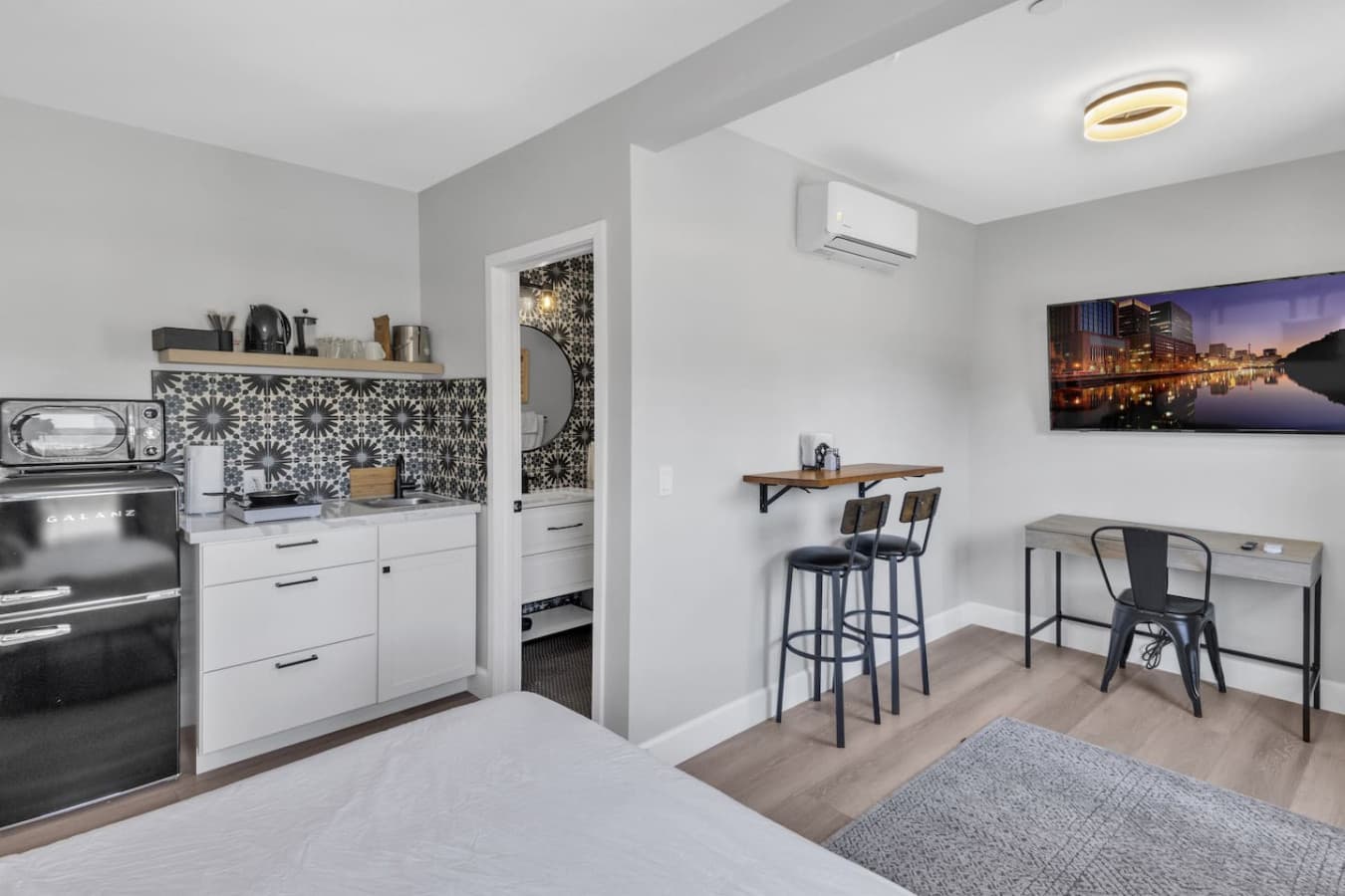 View of the kitchenette, dining area, workspace area, and TV