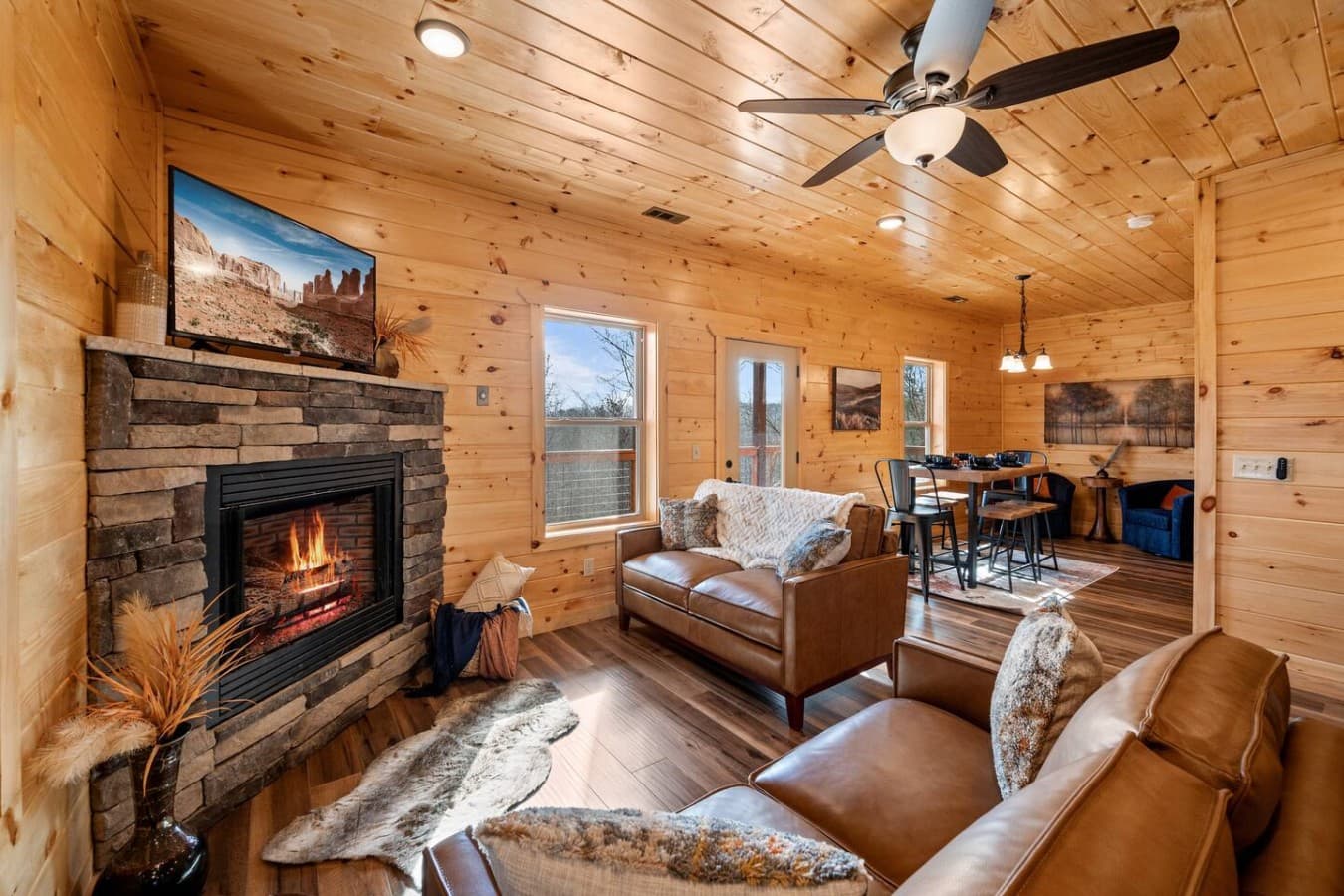 A Warm Welcome Awaits – Settle into this cozy, open-concept space, where the glow of the fireplace and nature’s beauty create the perfect retreat.