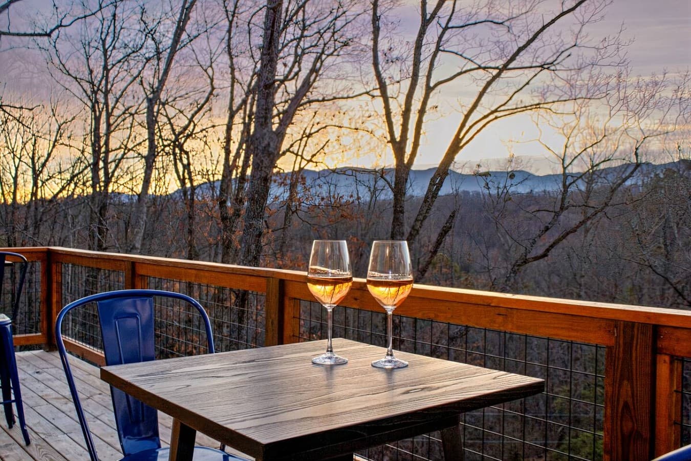 Wine, Views, and a Perfect Evening – The balcony’s stunning mountain views make every sip of wine taste even better.
