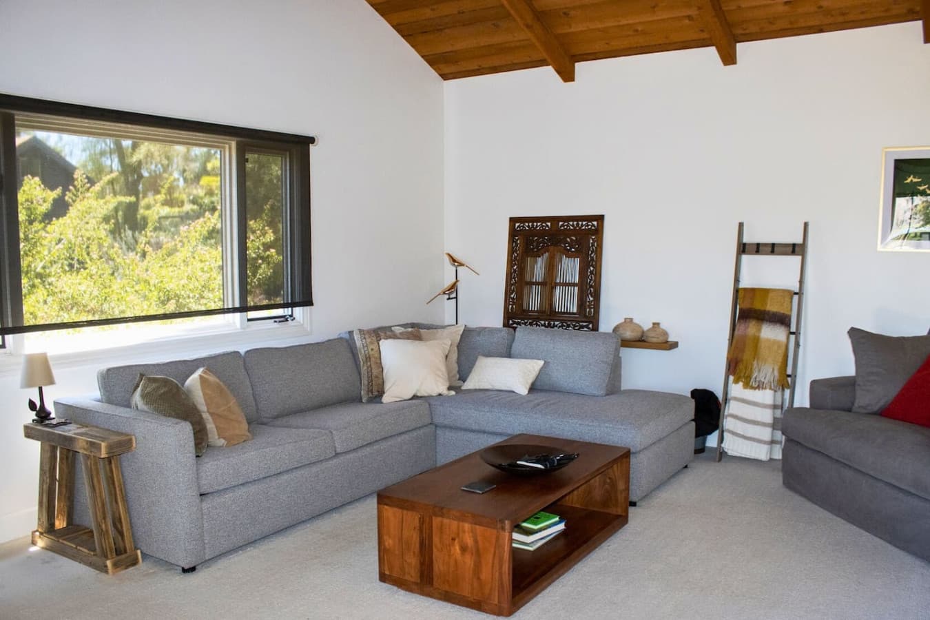 Spacious living room with stunning lake views and plenty of natural light for a relaxing atmosphere. The sofa conveniently pulls out into a comfortable queen bed for extra sleeping space.