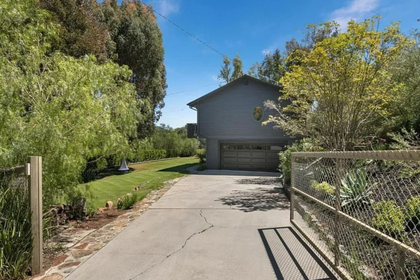 Private, gated entry with space for 4 cars in the driveway. Additional street parking is available, while the garage is closed for parking.