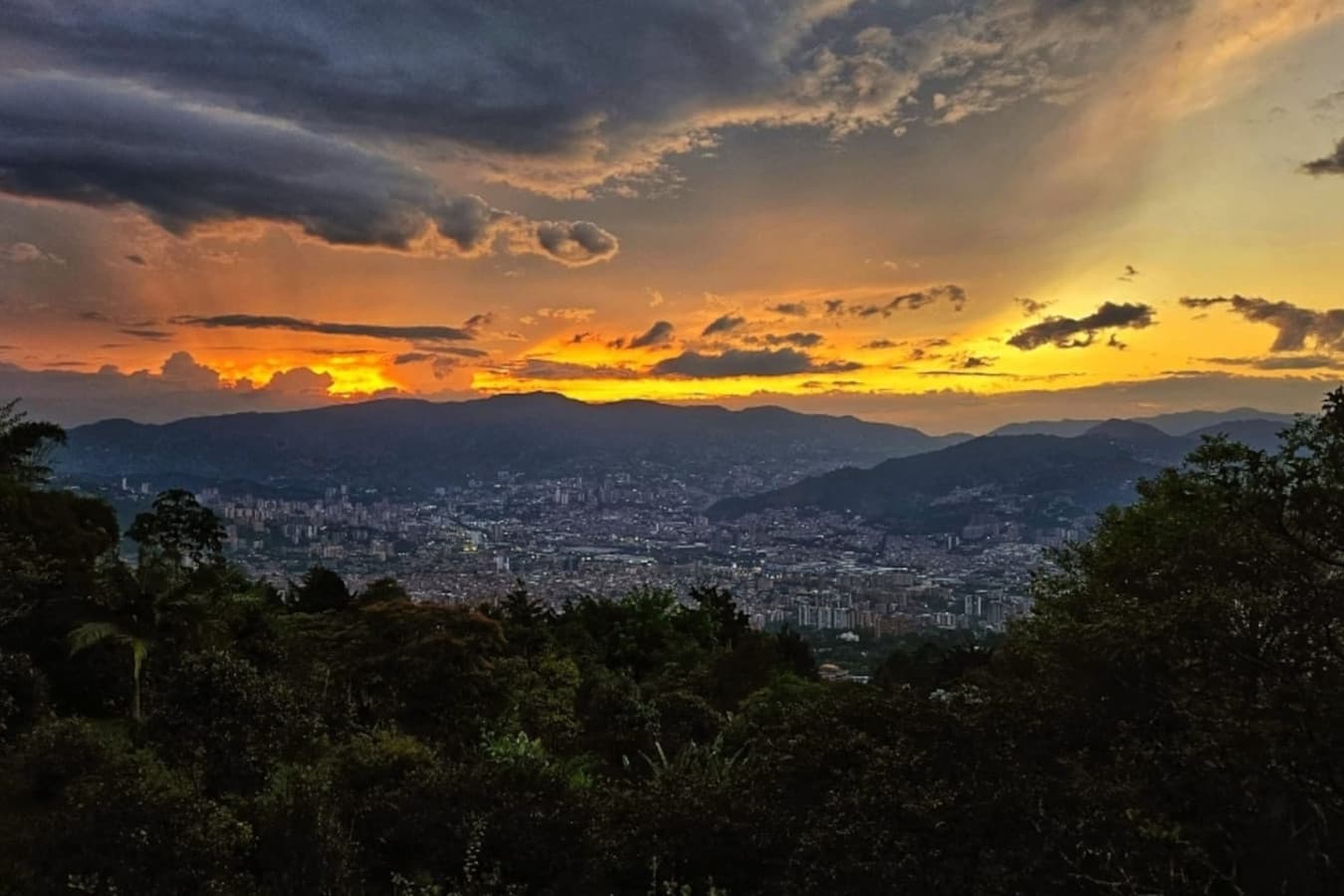 Front-row seats to Medellín’s sunsets, where vibrant skies meet twinkling city lights.