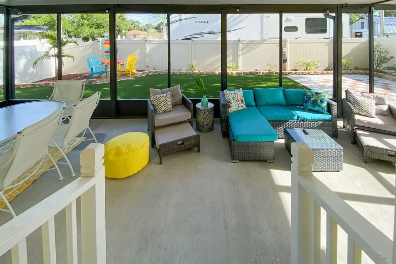 Sit back, relax, and enjoy the backyard views in this light-filled, cozy porch.