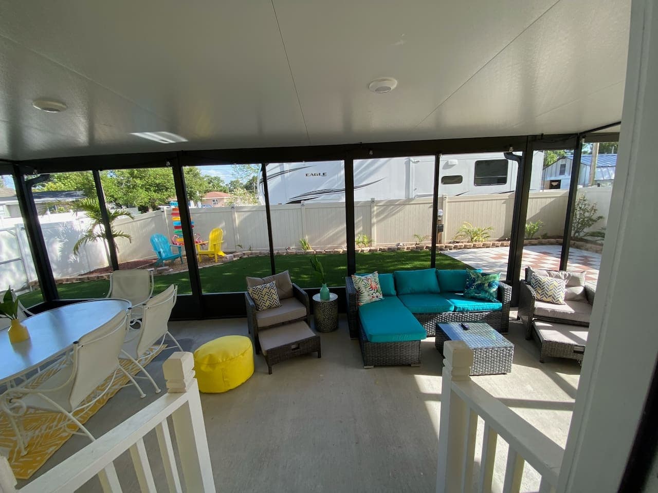 Enjoy the Florida breeze and sunny views from a comfy porch that blends indoor comfort with outdoor charm.