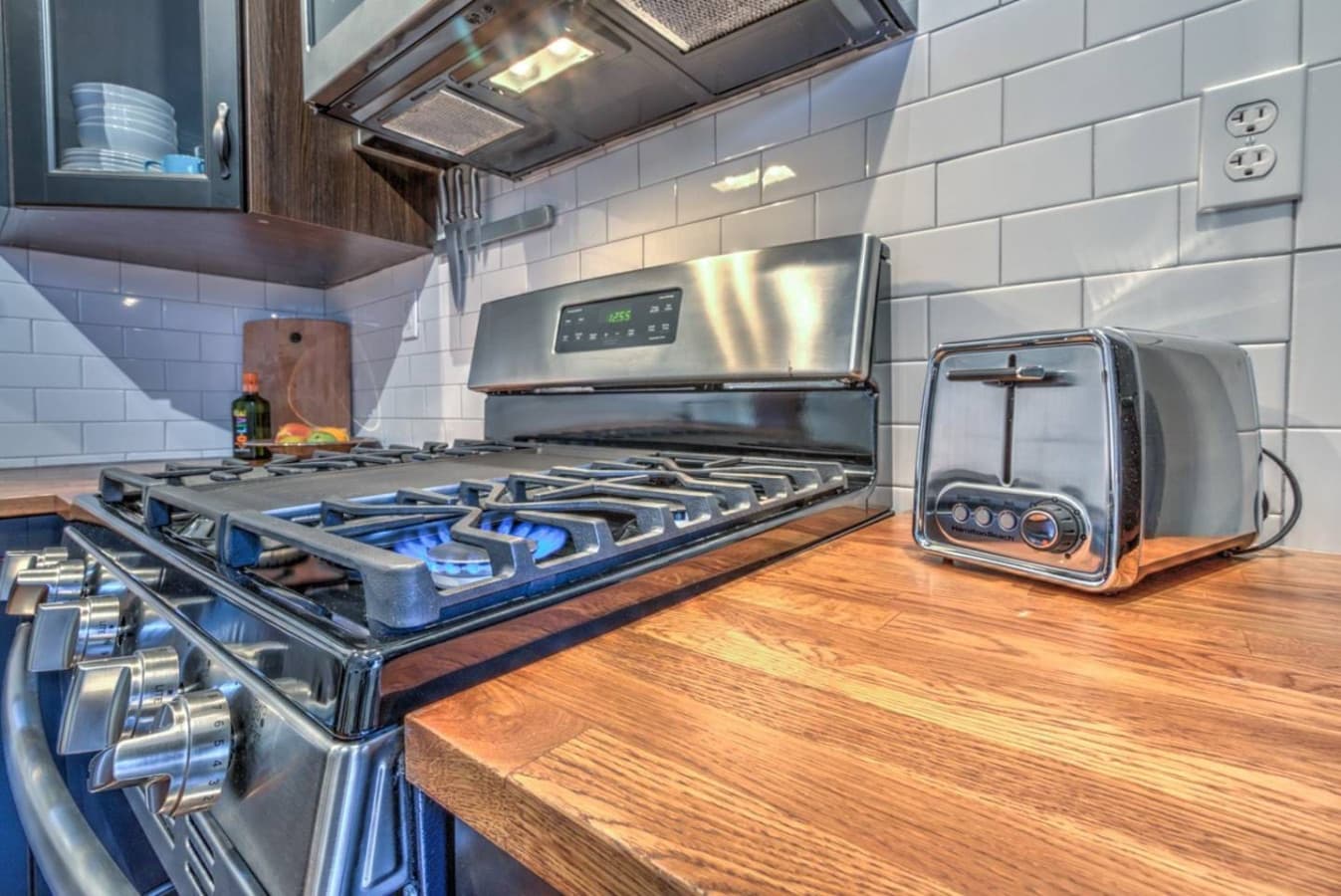 Convenient cooking setup with modern appliances, including stove, oven, and toaster.