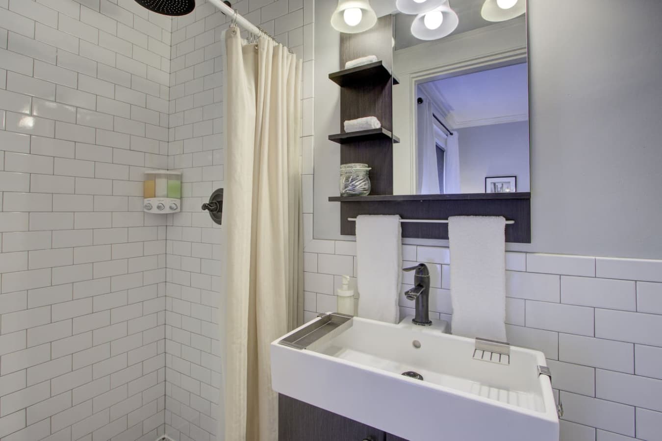 Crisp and clean bathroom with thoughtful touches for a relaxing stay.