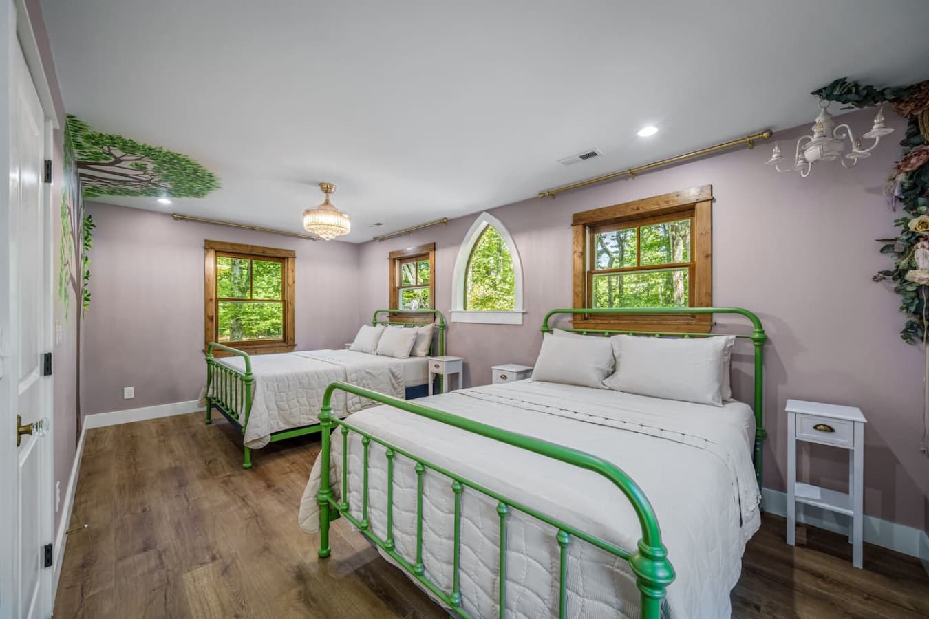 Two queen beds and trees on the walls—because even your dreams deserve a little adventure.