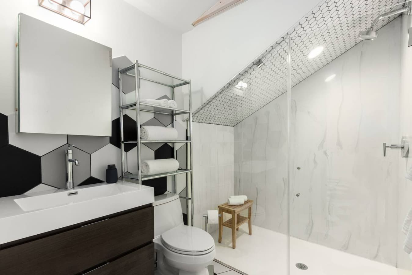 Simple luxury with a spa-like touch—this bathroom features a walk-in glass shower and fresh, minimalist style.