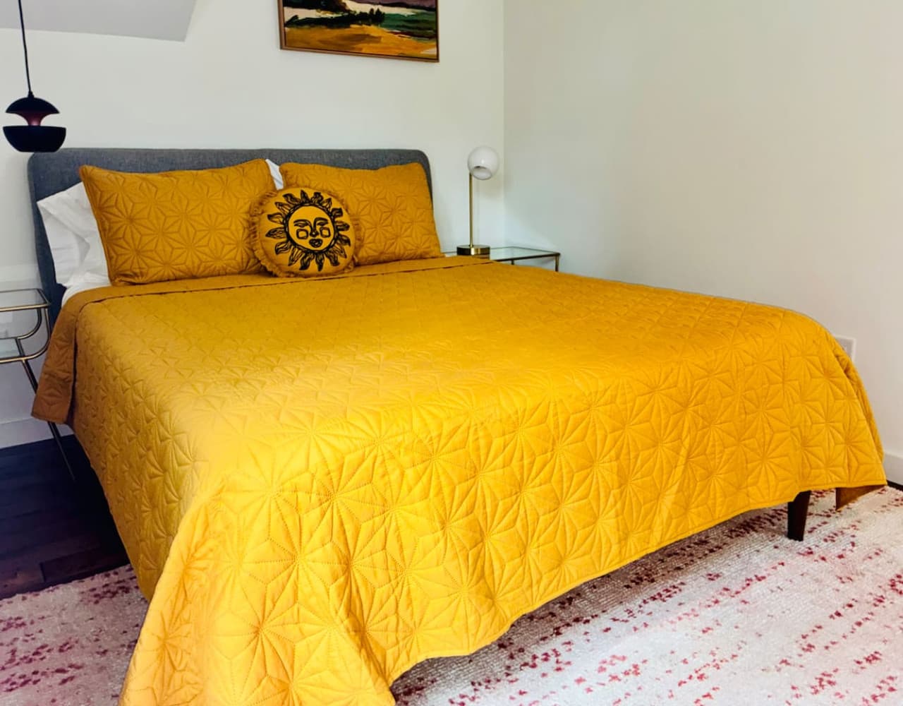 Queen bed set beneath vaulted ceilings for an open, airy feel.