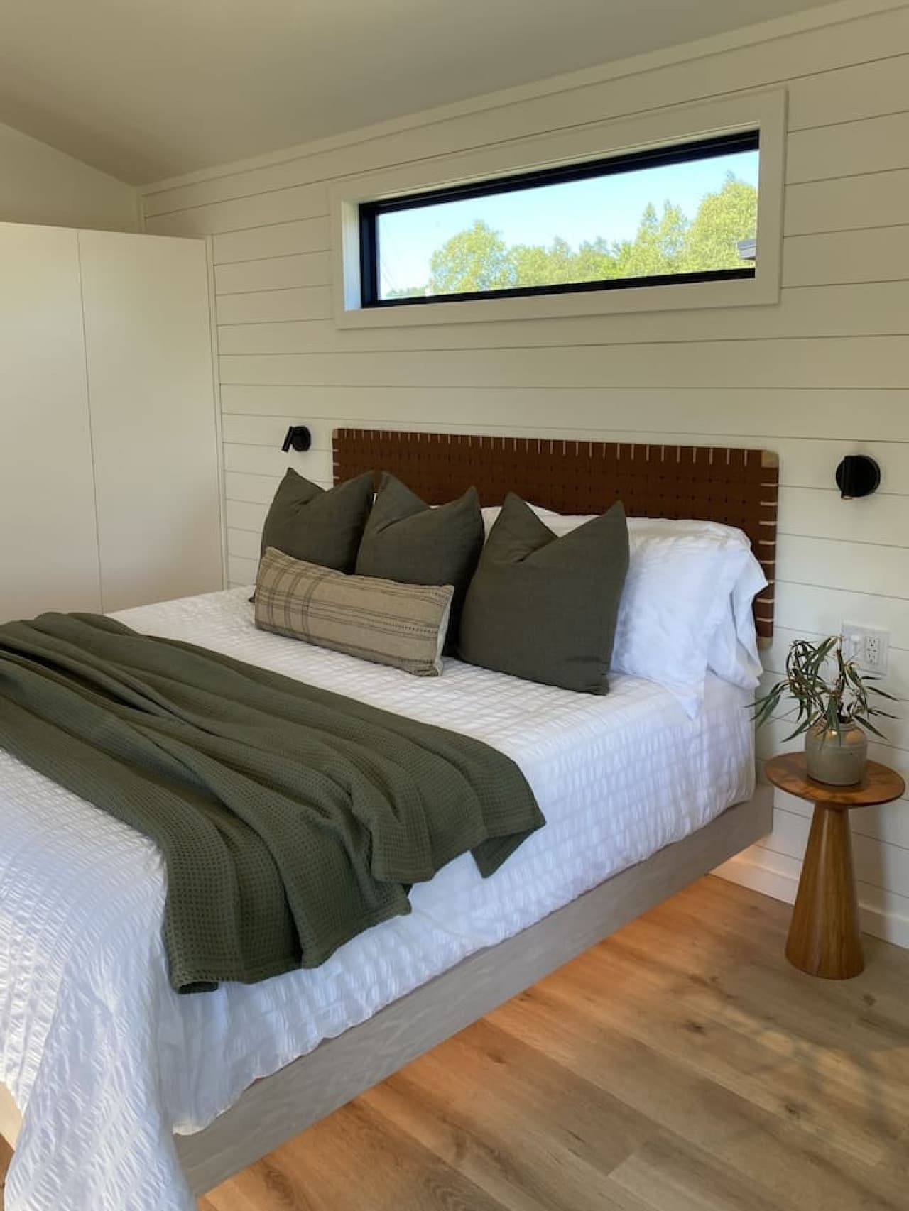 Drift off to the sound of the bay in a plush king bed, surrounded by soft lighting and calm coastal charm.