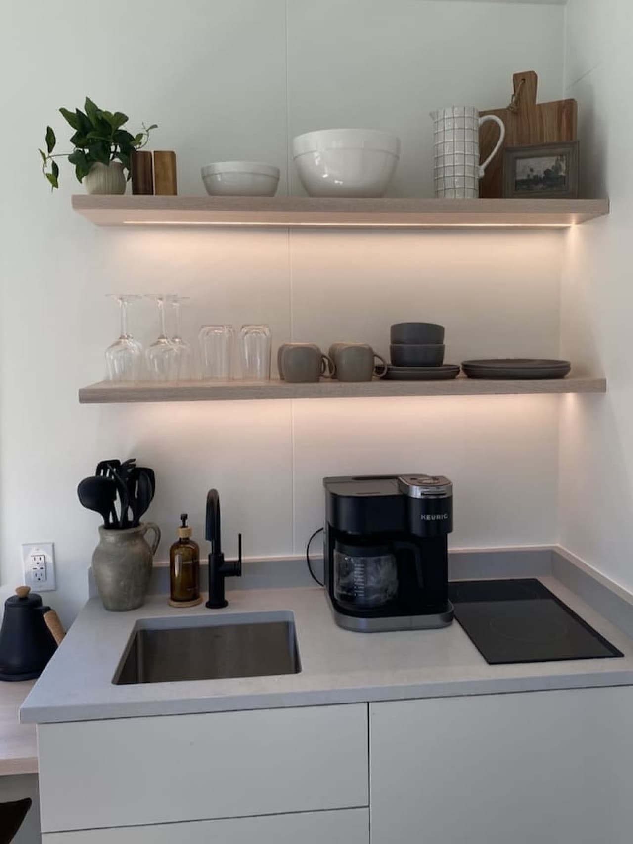 A modern kitchenette with essentials for effortless cooking during your Maine getaway.