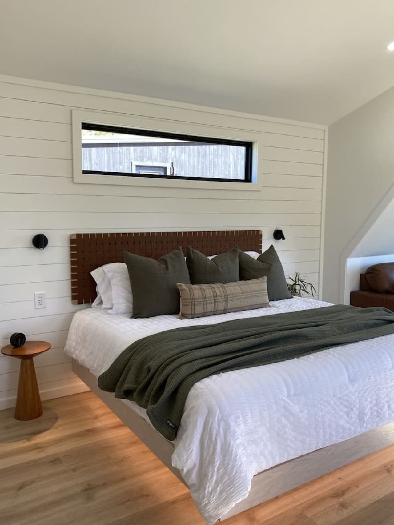 Drift off to the sound of the bay in a plush king bed, surrounded by soft lighting and calm coastal charm.