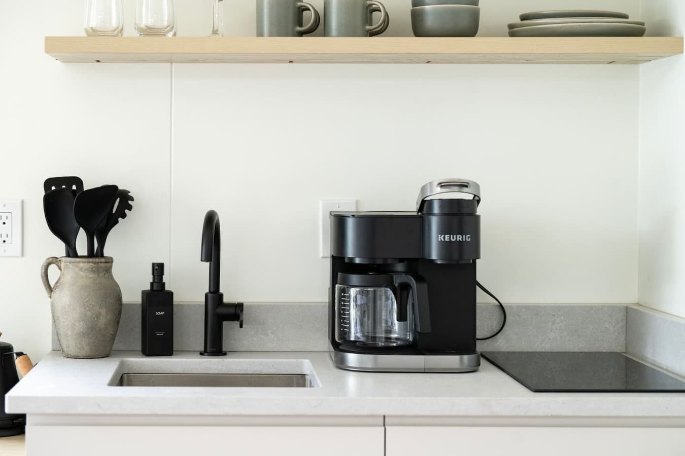 A modern kitchenette with essentials for effortless cooking during your Maine getaway.