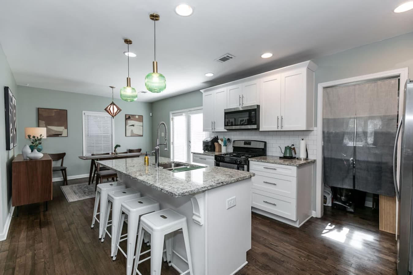 Sleek pendant lighting and stainless steel appliances make this kitchen as stylish as it is functional.