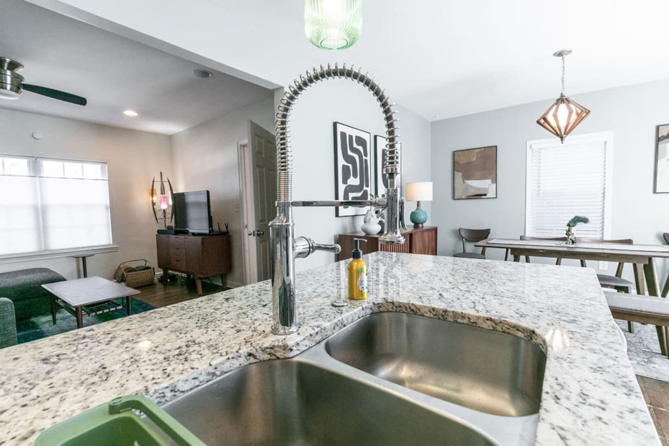 Details matter: an industrial-style pull-down faucet adds both utility and flair to the granite island.