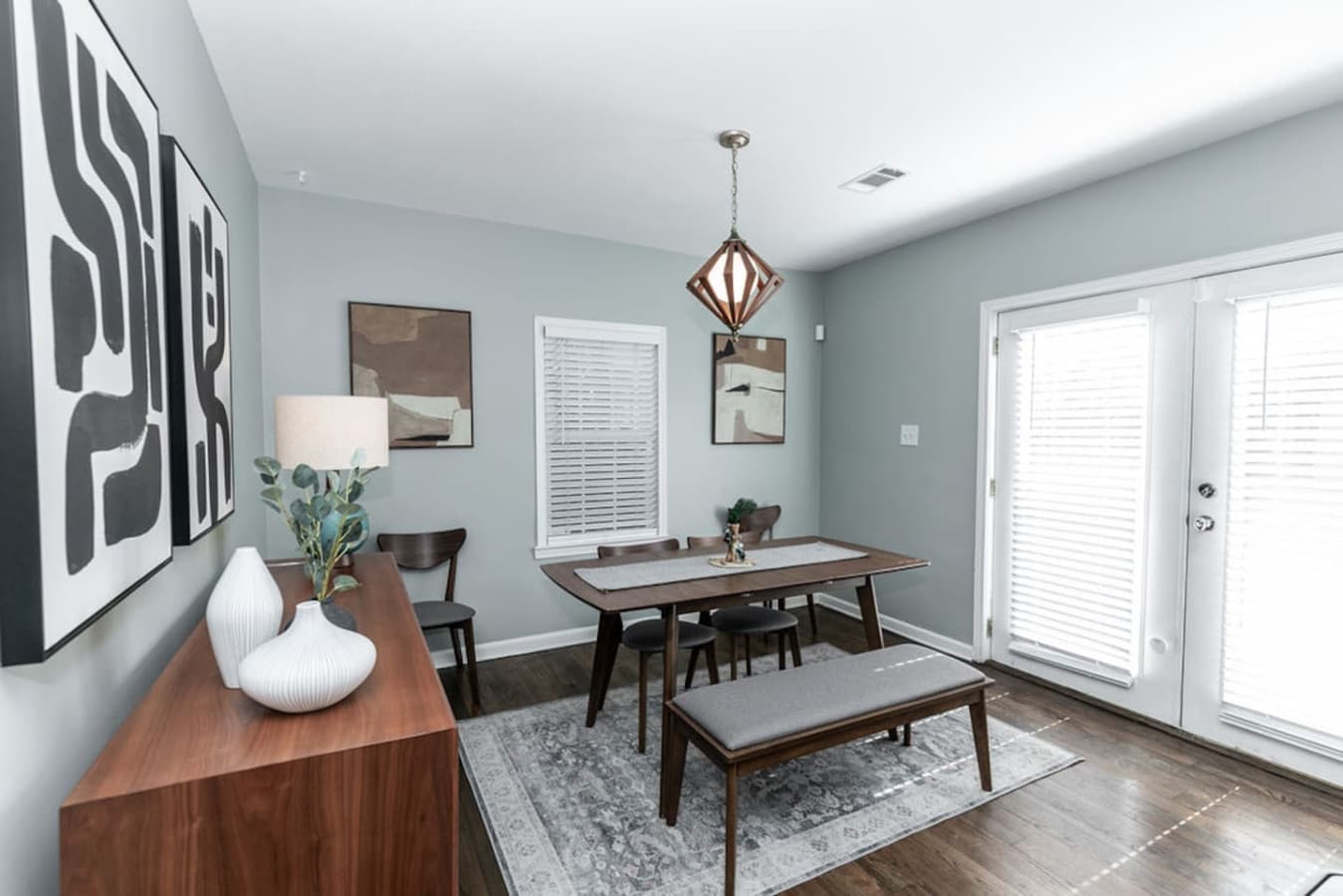 Transition seamlessly to the dining room, where designer lighting sets the mood for every meal.
