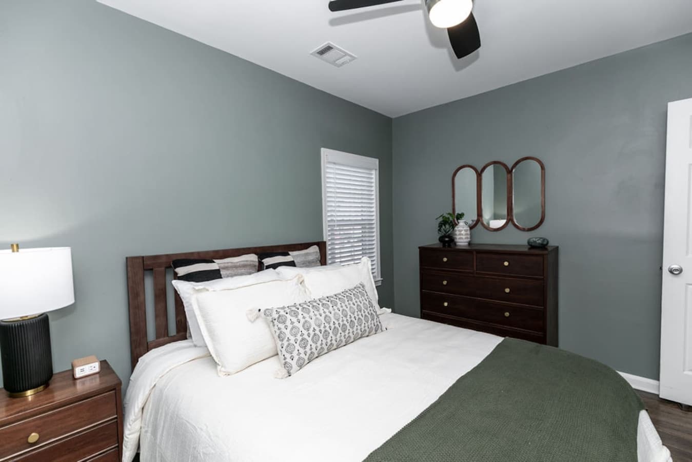 Comfort meets style in the queen guest bedroom, filled with natural light.