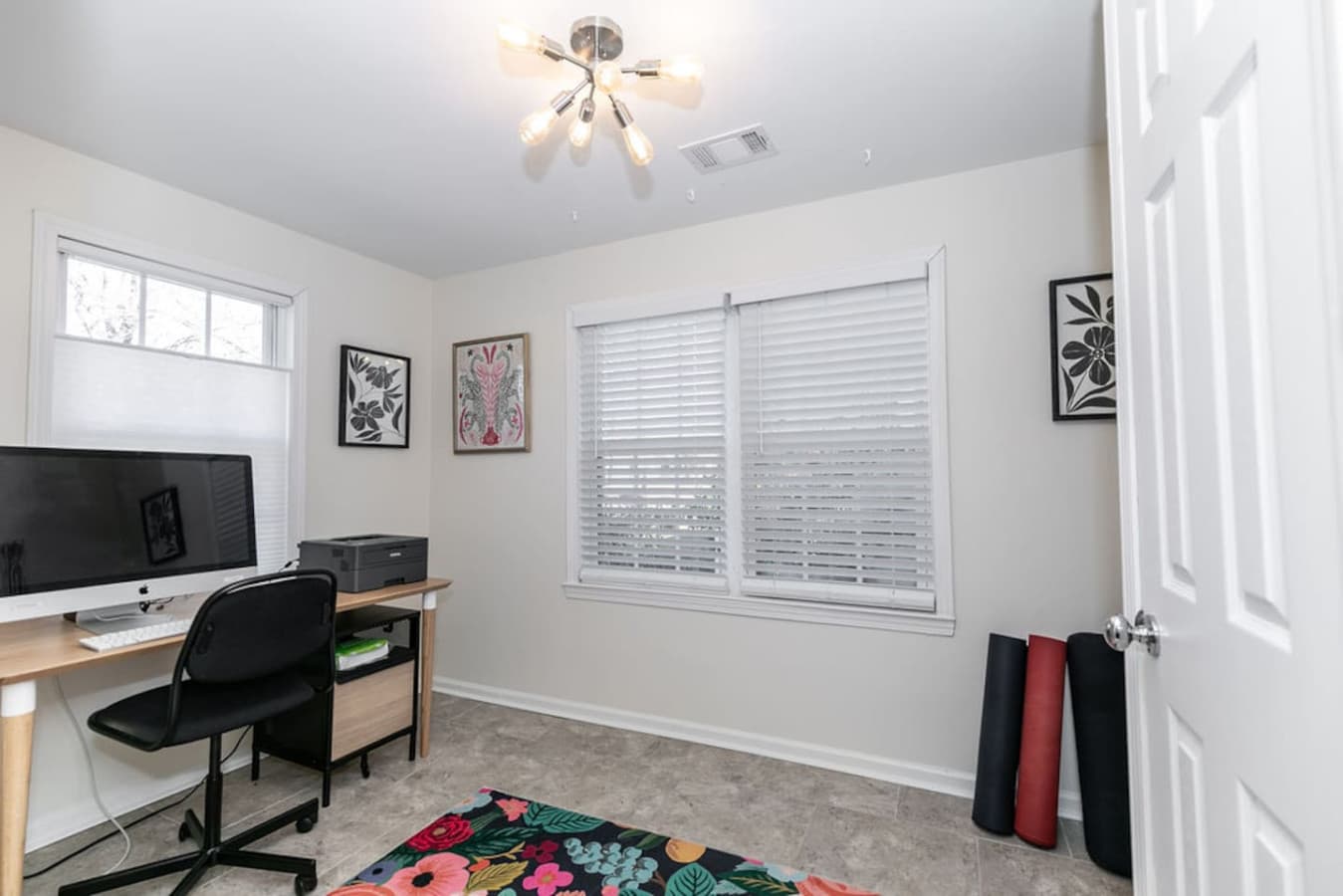 Desk, printer, and basic workout items make this a flexible office space.