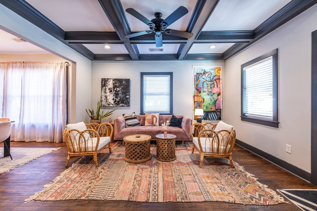 Cozy up in this inviting seating area featuring a plush mauve sofa and warm boho touches—perfect for reading, relaxing, or enjoying quiet downtime.