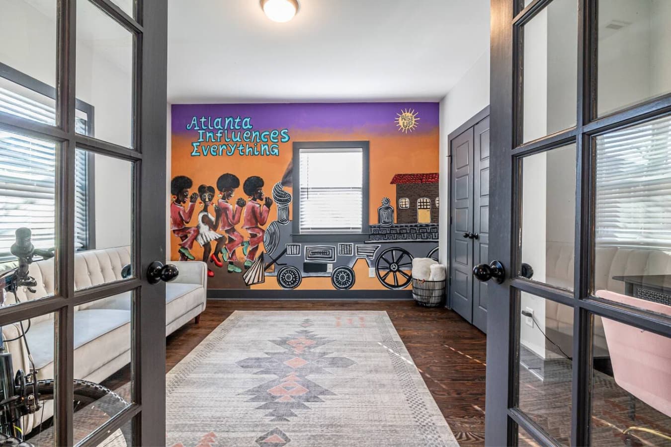 This flexible front room features a mural inspired by Gladys Knight, Atlanta’s own ‘Empress of Soul,’ and Westside Station — a nod to the city’s vibrant cultural history that inspired the home’s name.