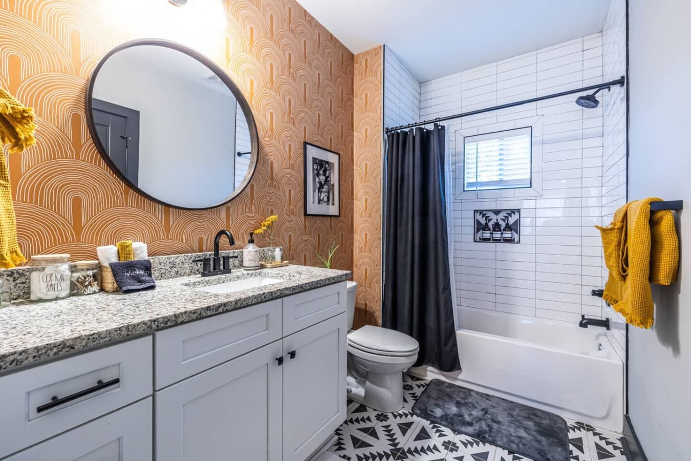A warm, boho-inspired bathroom offering access from both the hallway and the guest room, blending style and convenience.
