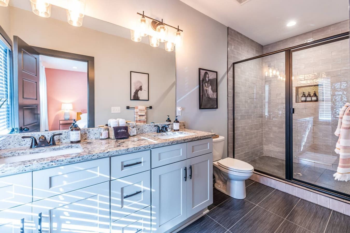 This elegant bathroom boasts a double vanity and a spacious, spa-inspired shower for a relaxing experience.
