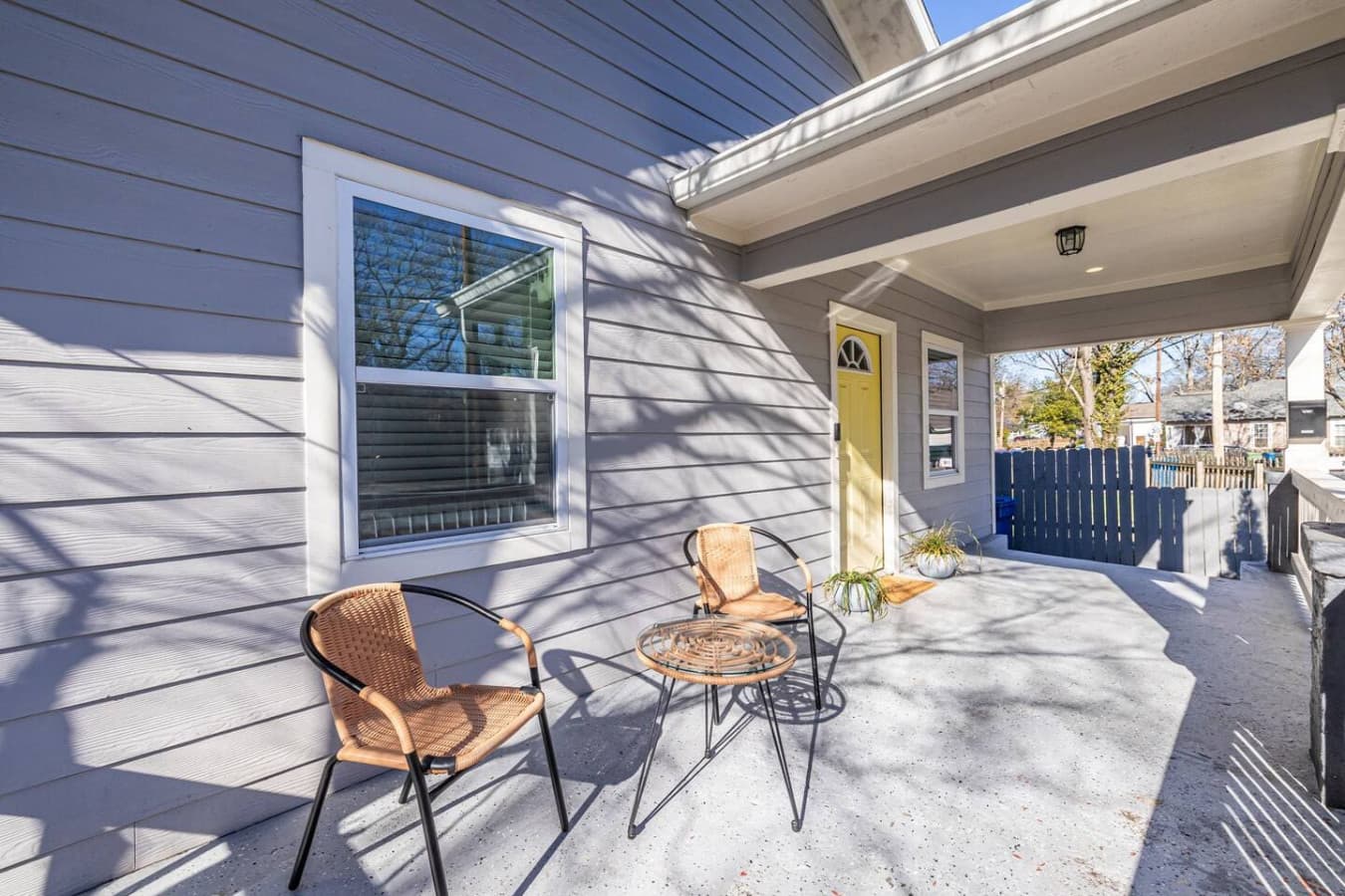 A classic Southern-style front porch, perfect for relaxing and enjoying the neighborhood ambiance.