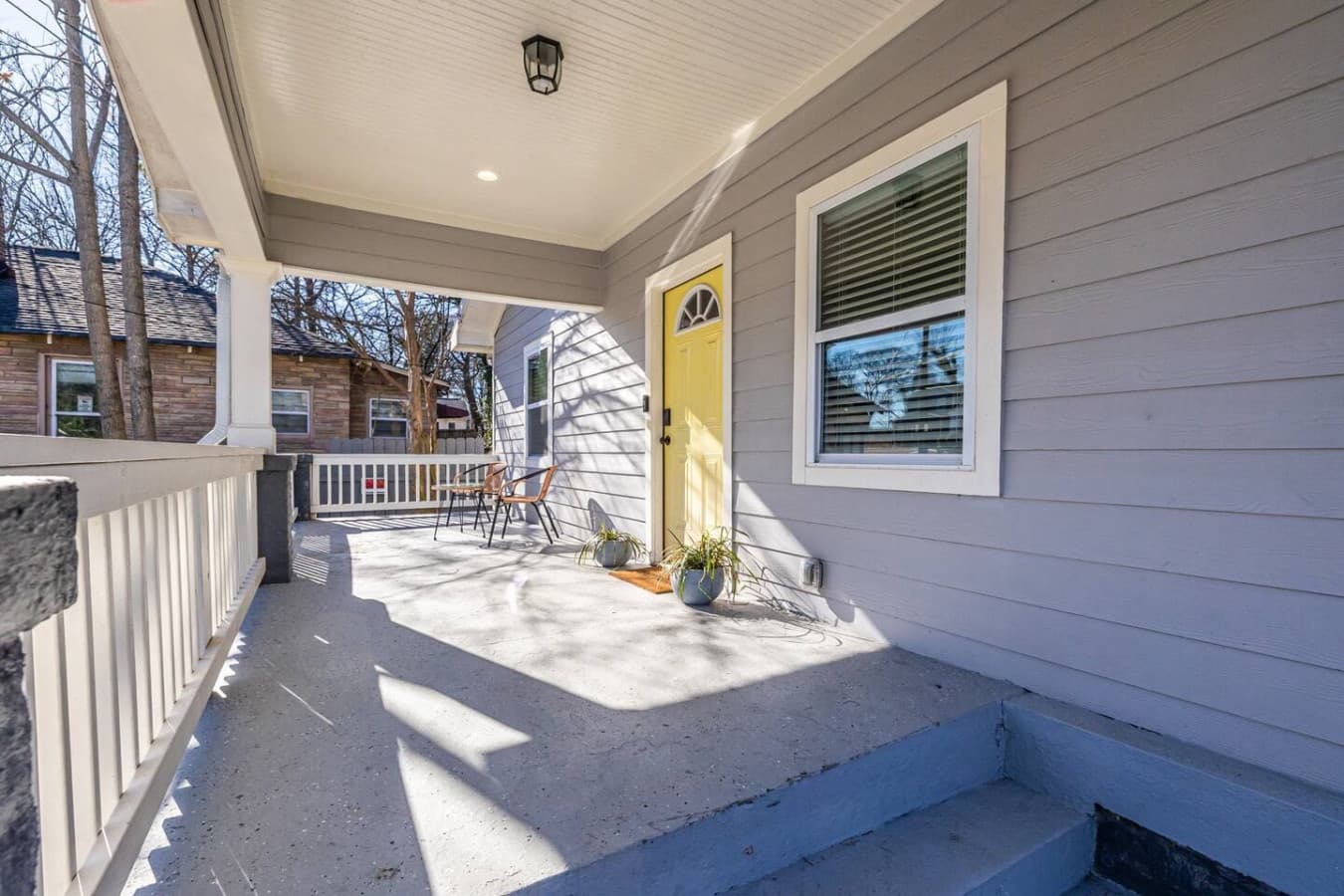 This charming front porch offers a cozy spot to unwind and greet guests.