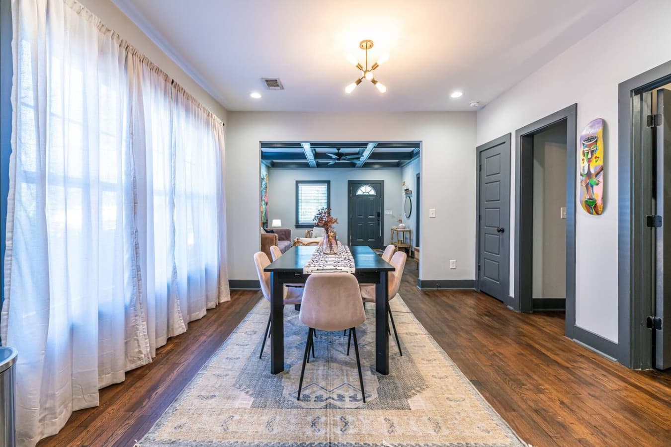 Bright and stylish dining space with a sightline to the living room and front entry, ideal for gathering with family, sharing a meal, or unwinding with a glass of wine.