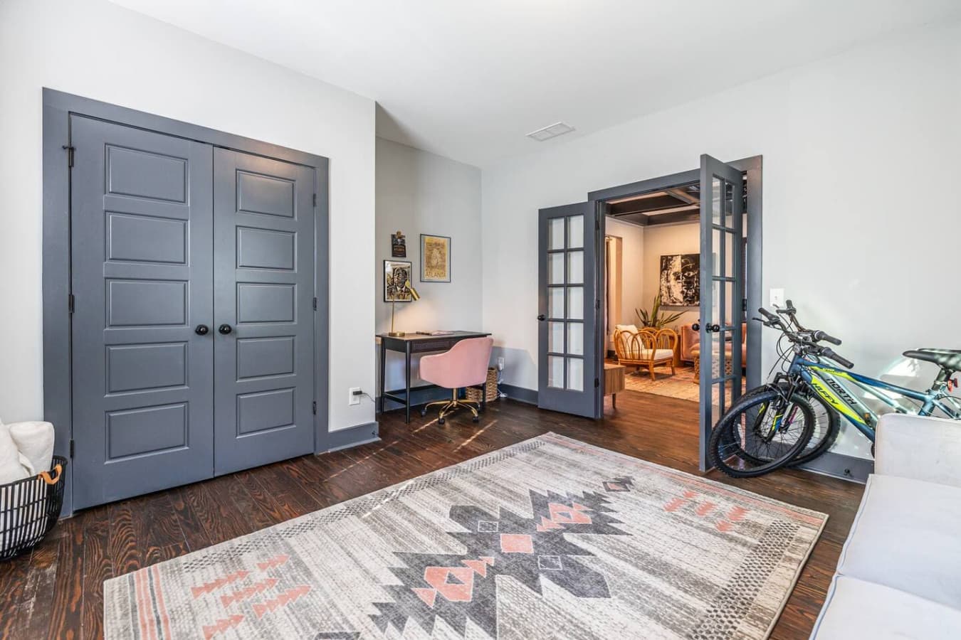 Set up for productivity, this front room features a dedicated desk and workspace, perfect for remote work or study, with natural light and easy access to the rest of the home.