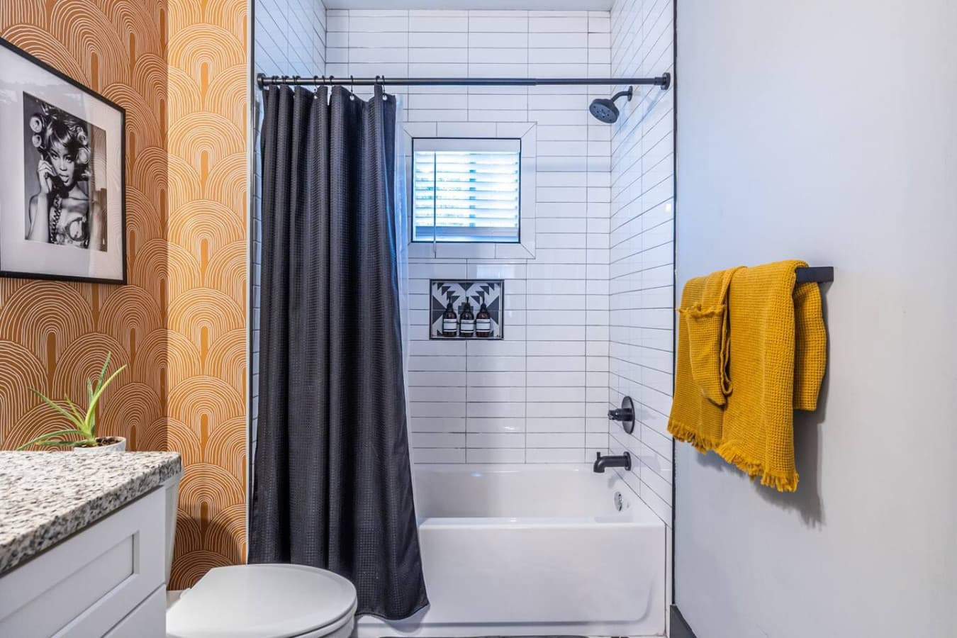 Cozy bathroom features a shower-tub combo and welcoming accents that create a comfortable, stylish space.