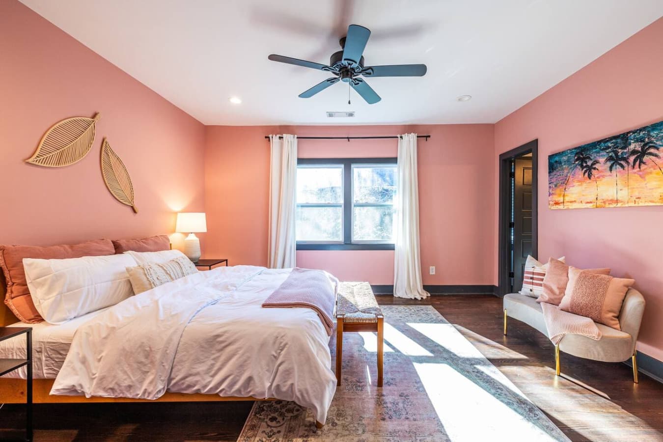 A serene primary bedroom featuring a king bed and soothing mauve tones, creating a peaceful retreat for rest and relaxation.