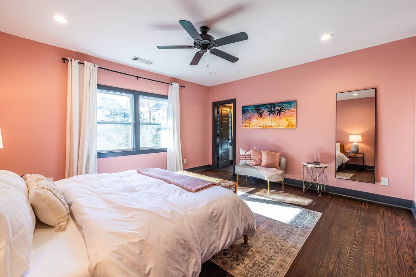 Relax in the generous primary bedroom, complete with a king bed and tranquil décor.