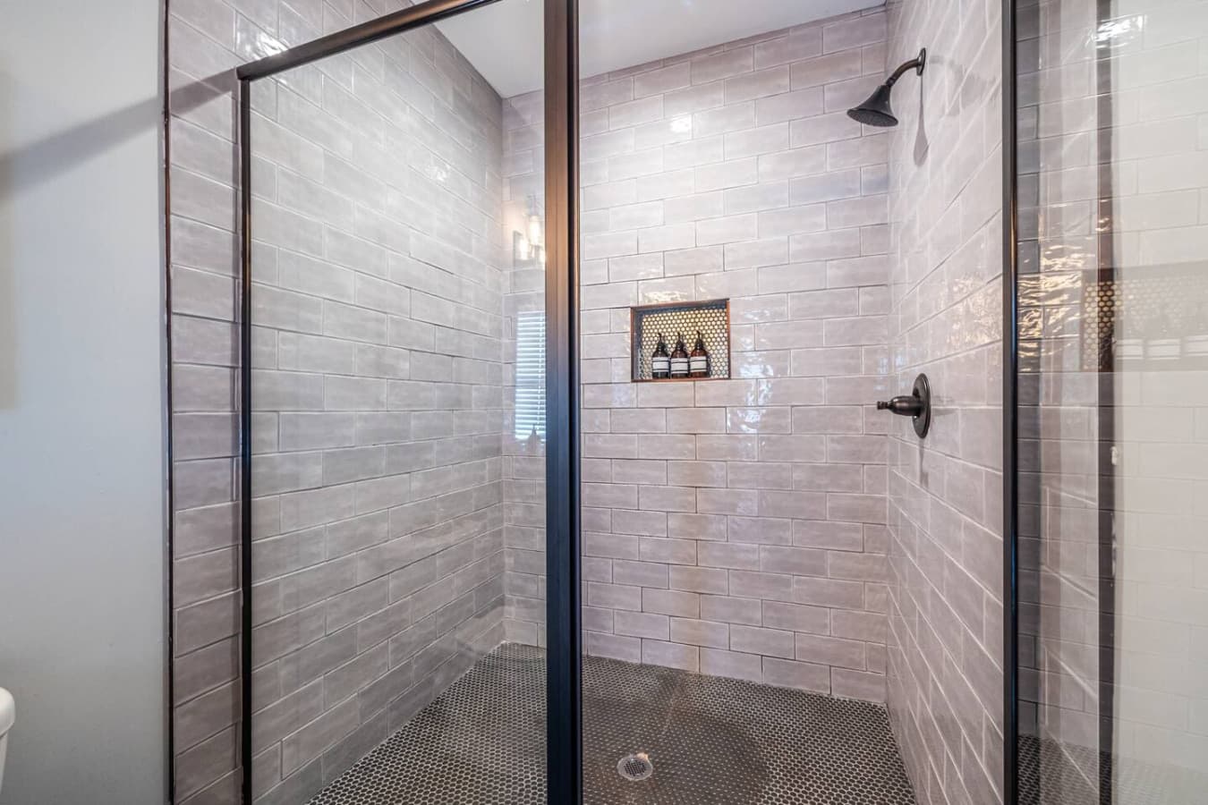A serene primary bathroom featuring a spa-like shower for a relaxing, rejuvenating experience.
