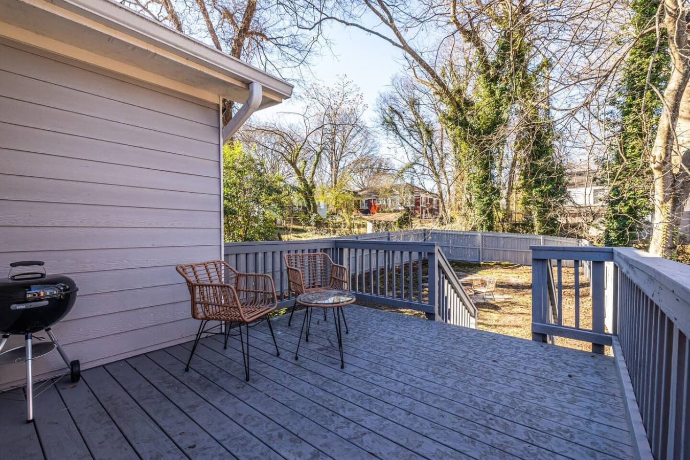 This inviting deck offers a grill and seating, ideal for enjoying meals or relaxing in the fresh air.