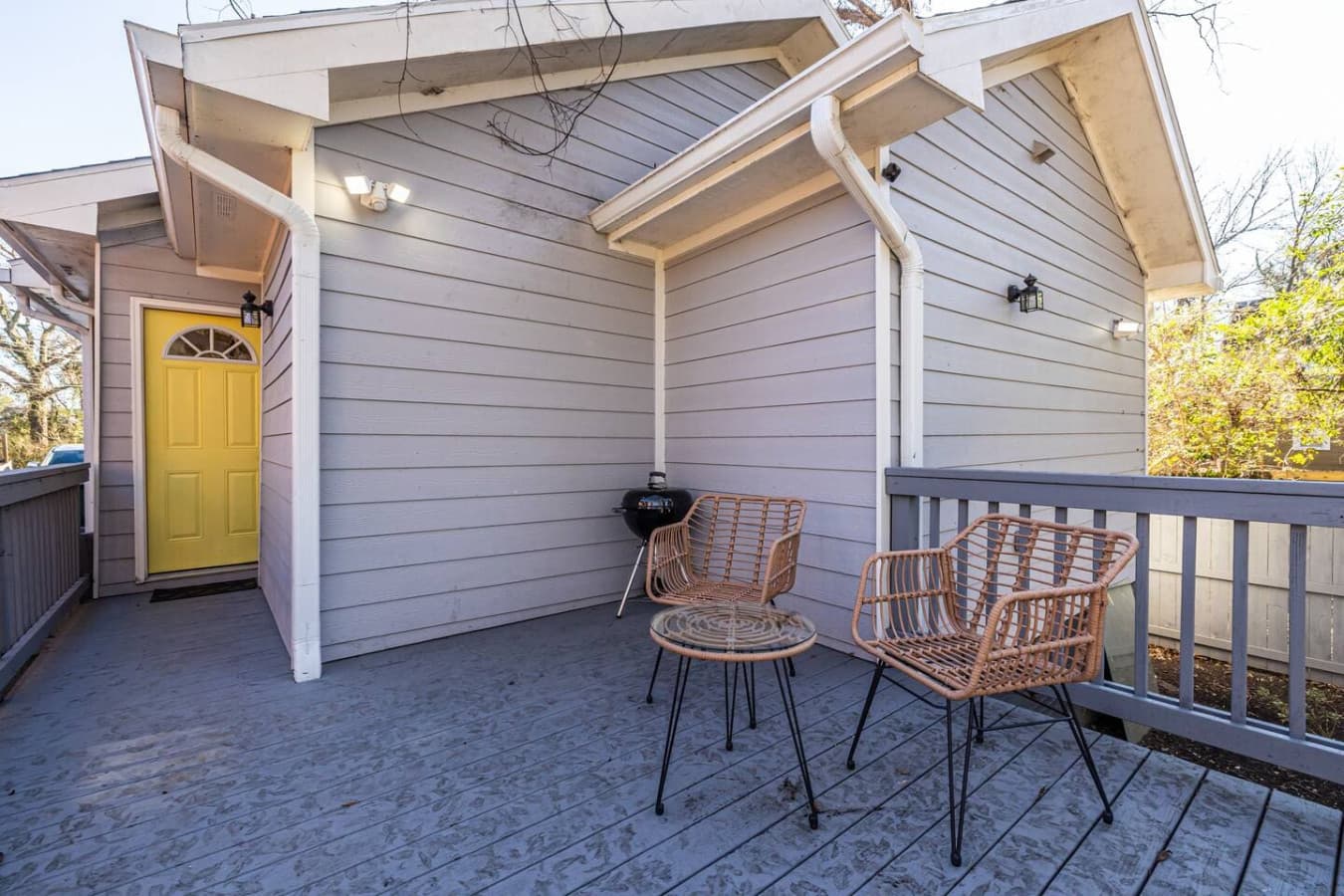 Step outside to the back deck, equipped with a grill and chairs for casual dining and outdoor leisure.
