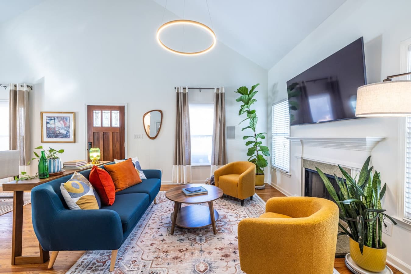 Start your morning with coffee and sunshine in this bright, airy living room filled with bold color and mid-century charm.