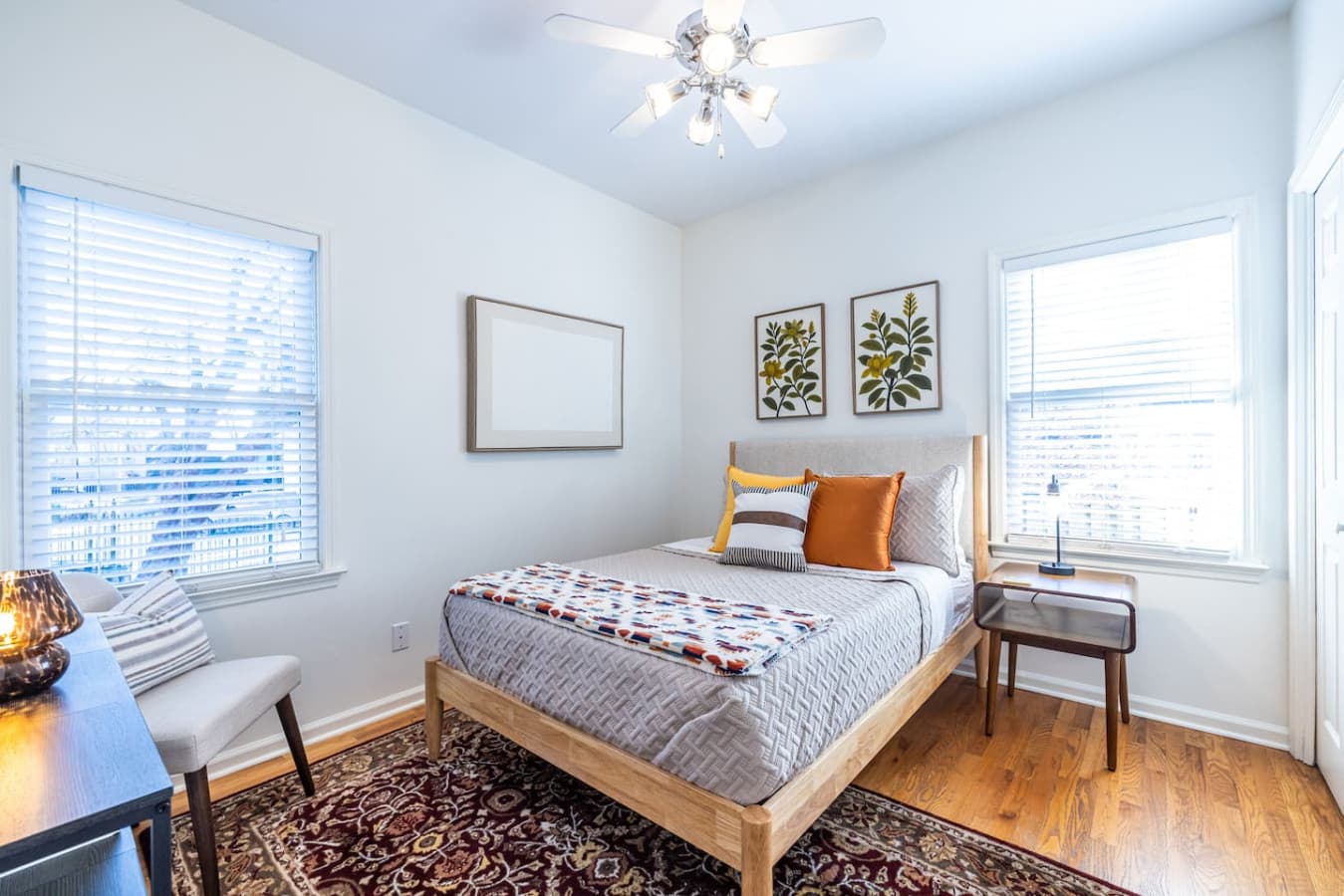 Fresh, inviting bedroom with a full-size bed and plenty of natural light.